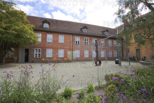 Cultural Forum and Schleswig-Holstein House, brick building, sculpture, inscription, Schelfstadt,