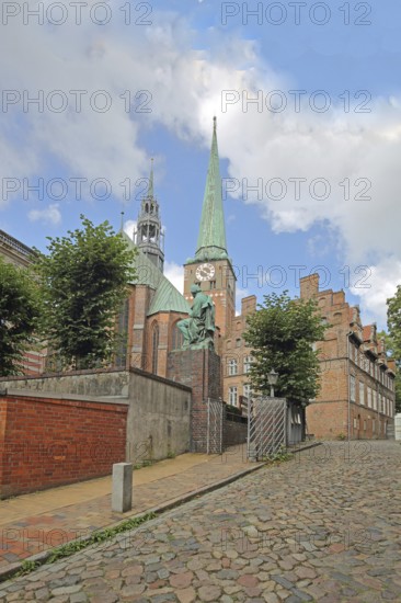 Monument to writer and poet Emanuel Geibel by Hermann Volz 1889 and St Jakobi Church, brick church,