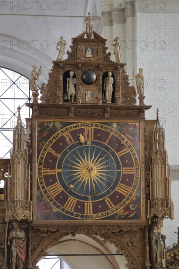 Rood screen with Gothic clock built in 1477 with decorations and figures, interior view, church