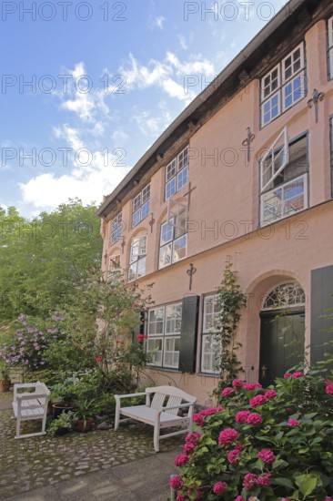 Idyllic Füchtingshof with flower decoration, hydrangea, benches, ornamental plants, potted plants,