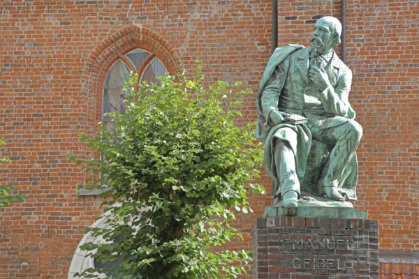 Monument to the writer and poet Emanuel Geibel by Hermann Volz 1889, seated, inscription, bronze