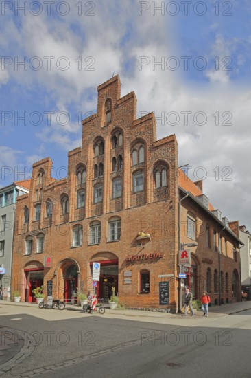 Historic lion pharmacy with stepped gable, brick building, pedestrian, pharmacy, old town, Lübeck,