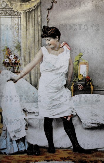Female nude from around 1899, erotic postcard, playgirl, woman in nightgown looking at herself in