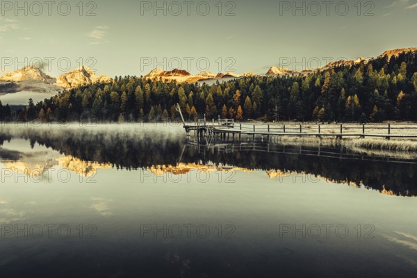 Lake Staz near Sankt Moritz in the Engadin in Switzerland. Morning atmosphere with fog in autumn.