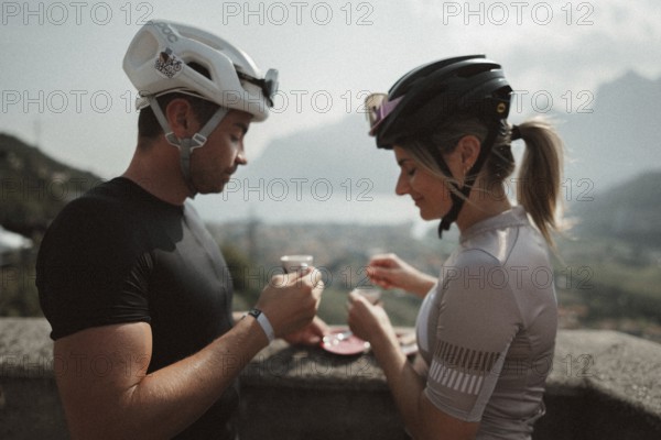 Young man taking a coffee break while riding his racing bike on Lake Garda. Sunny weather and dolce