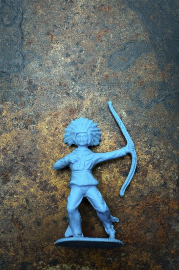 A vibrant blue plastic toy archer stands confidently, showcasing its detailed representation of an