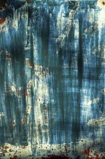 The surface displays an interplay of blue and white hues, layered textures, and hints of rust,