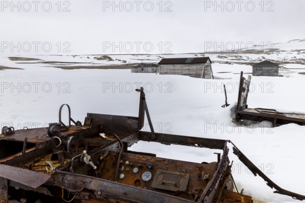 Former research station, rusty vehicle, wooden hut, Kinvika, Muchinsonfjord, Spitsbergen, Svalbard