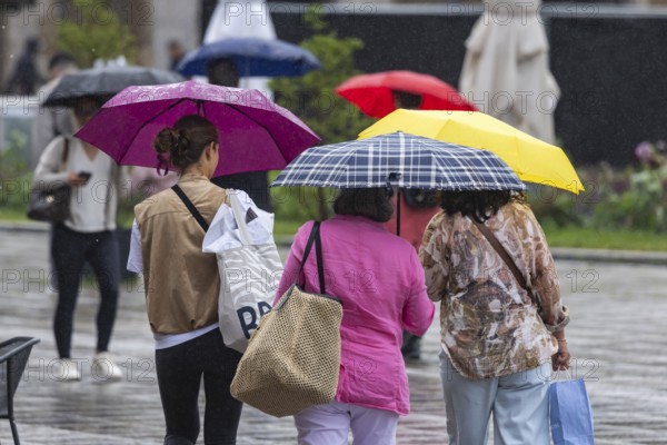 Rainy weather in Stuttgart. People with umbrellas hurry through the rain on Königstraße. Stuttgart,