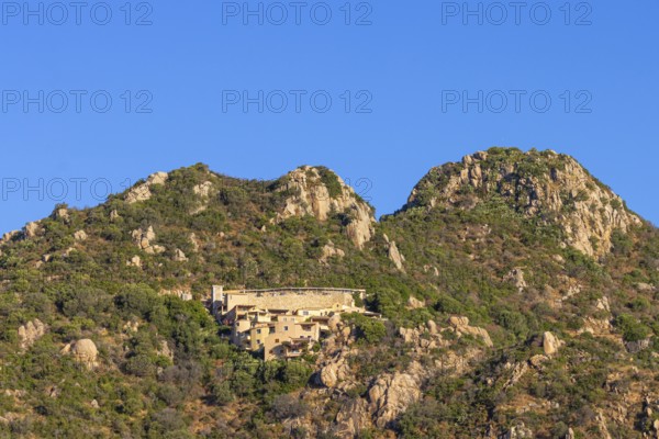 Small houses built into the steep, rocky slope characterise the landscape on the Costa Rei, a