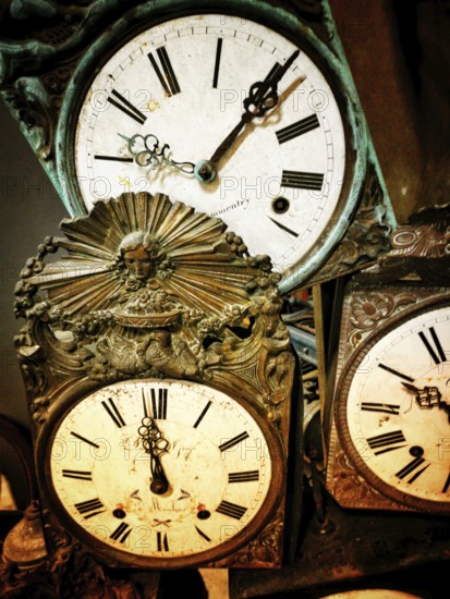 A collection of vintage clocks showcasing ornate craftsmanship and classic styling. Each clock