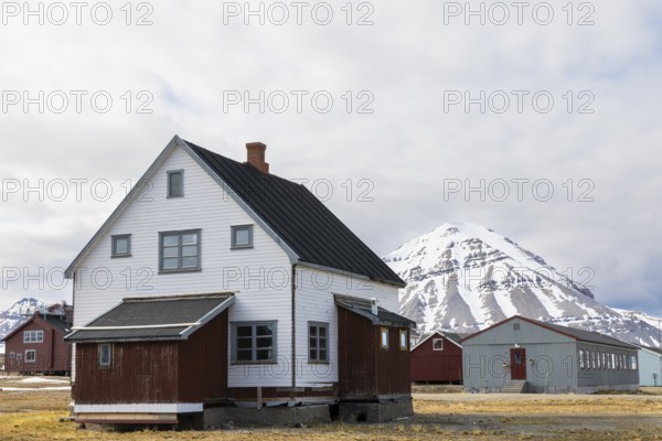 Wooden house in front of a mountain peak, Ny-Alesund, Spitsbergen, Svalbard