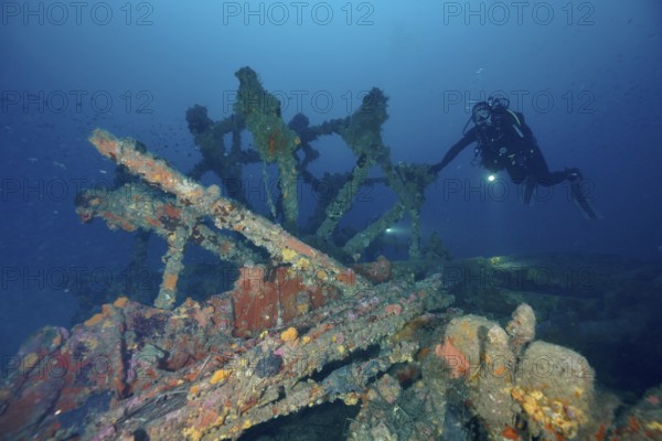 Diver examines the remains of an old shipwreck. Dive site wreck Ville de Grasse, Giens peninsula,