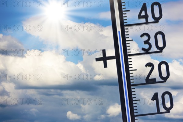 Symbolic image, global warming, thermometer shows high temperatures under a sunny sky with clouds,