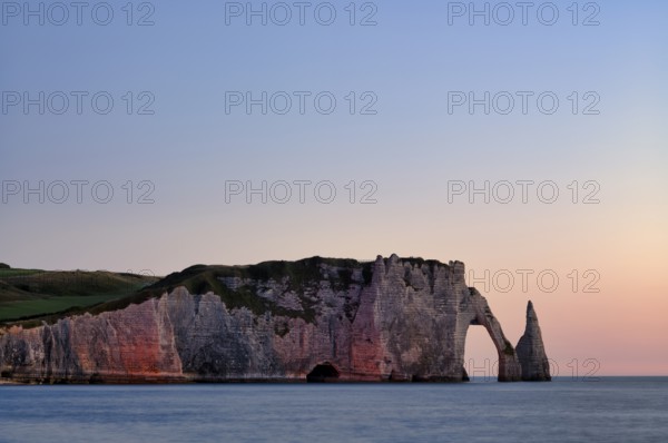 Rock arch Falaise or Porte d'Aval and rock needle Aiguille, illuminated, illuminated, Étretat, sea,