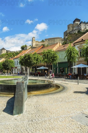 Mark Aurel fountain and fountain on Peace Square with Trencin Castle in the background, Capital of