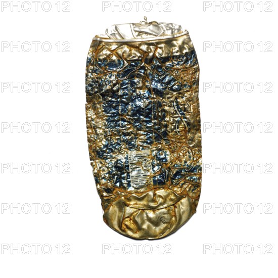 A crushed beer can rests on a city sidewalk, highlighting issues of litter and pollution. Its worn