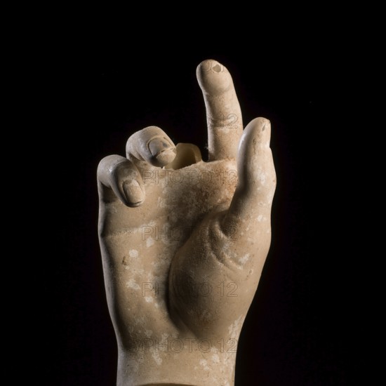 A sculpted hand gesture captures attention with its realistic depiction. The focus is on the