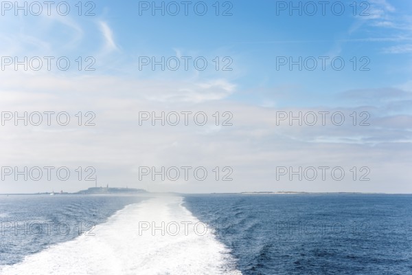 Wide boat track, water track, foam track leading towards the islands of Heligoland (main island and
