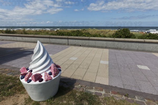Decorative sundae with strawberries and icing on the cake, eye-catcher on the beach promenade,
