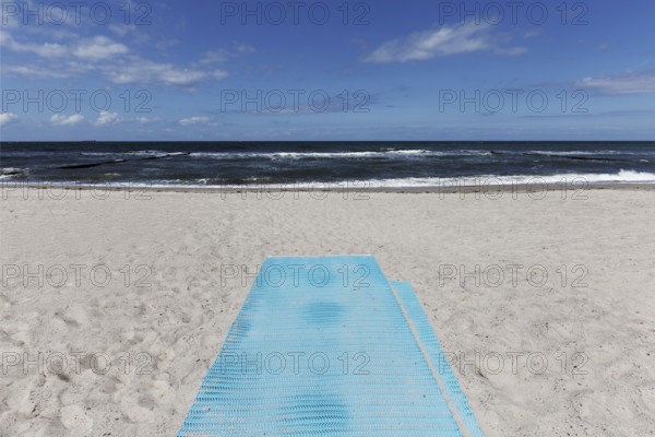 Deserted beach with blue sand mat for barrier-free beach access, blue sky, Kühlungsborn, Baltic