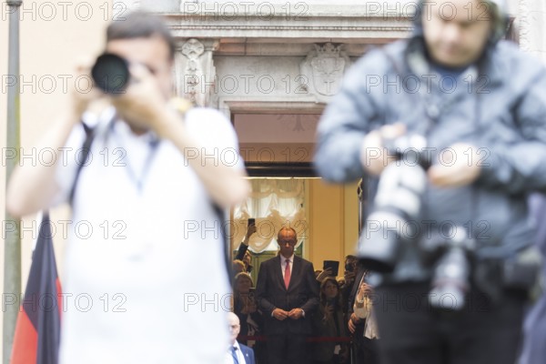 Friedrich Merz (CDU, German Chancellor) waits behind photographers for Emmanuel Macron (President