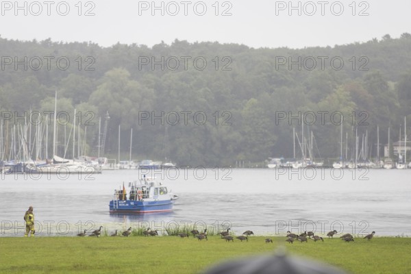 A water police boat guards the shore of Villa Borsig in front of a joint meeting between Friedrich