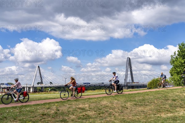 Cycle path in the Neulandpark in Leverkusen on the Rhine, in the background the new Rhine bridge of