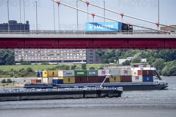 Barges on the Rhine at Ruhrort harbour, container freighter on uphill journey,