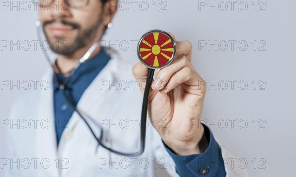 Doctor holding stethoscope with North Macedonia flag. North Macedonia health and care concept,