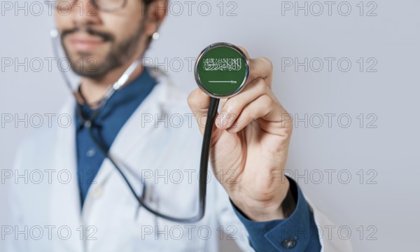 Doctor holding stethoscope with Saudi Arabia flag. Saudi Arabia health and care concept, Saudi