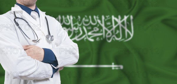 Saudi Arabia healthcare concept. Male doctor on Saudi Arabia flag. Doctor with crossed arms on
