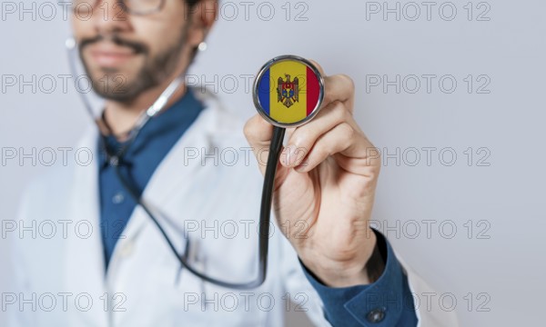 Doctor holding stethoscope with Moldova flag. Moldova health and care concept, Moldova flag on