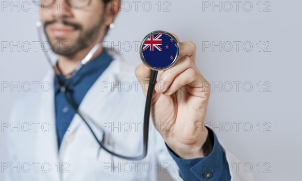 Doctor holding stethoscope with New Zealand flag. New Zealand health and care concept, New Zealand