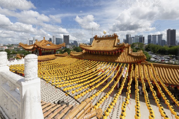 Thean Hou Temple to the Goddess Mazu with yellow chines lanterns and Kuala Lumpur skyline,