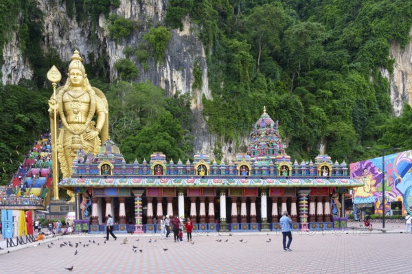 Murugan statue the God of War and colorful staircase leading to the caves with many pilgrims, Batu