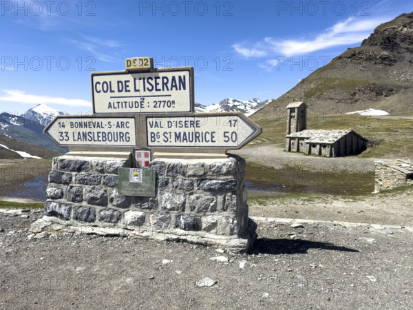In the foreground signpost to the pass summit of the highest navigable alpine pass Col de l'Iseran