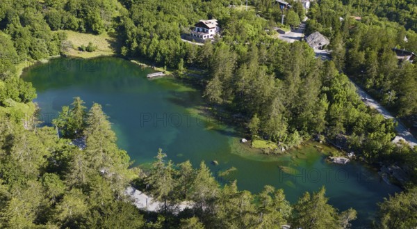 Aerial view Bird's eye view of small mountain lake Alpine lake Lago Grande near Moncenisio behind