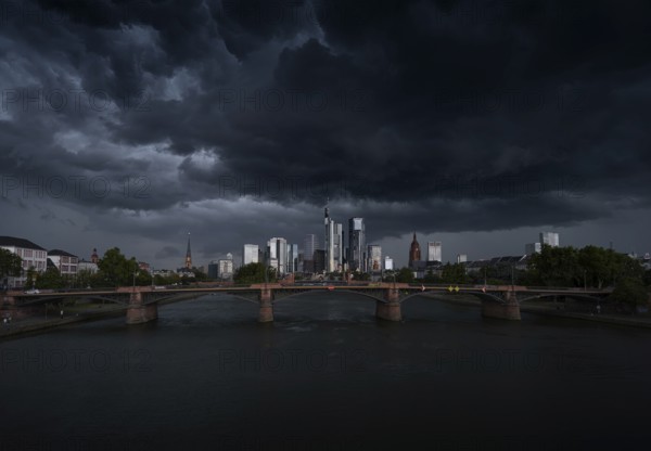 A storm passes over the Frankfurt banking skyline with gloomy clouds, Frankfurt am Main, Hesse,