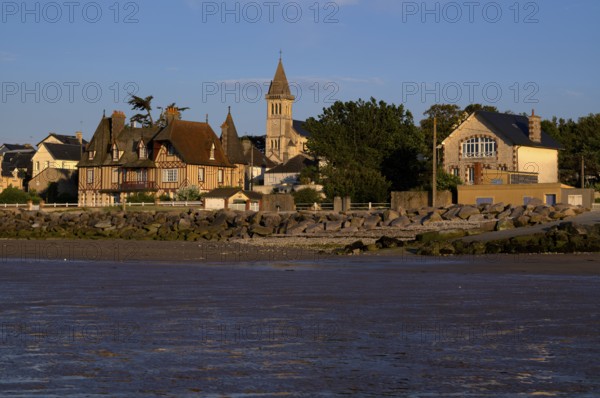 View at low tide from the beach to the church Église Notre-Dame de Grandcamp-Maisy, village,