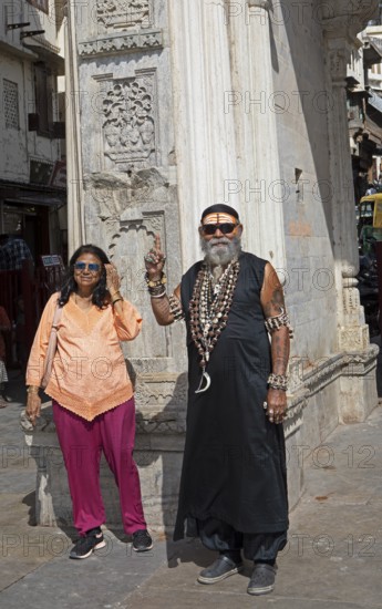 Indian couple, tattooed, with skull chains at Gangaur Ghat or Gangori Ghat, Udaipur, Rajasthan,