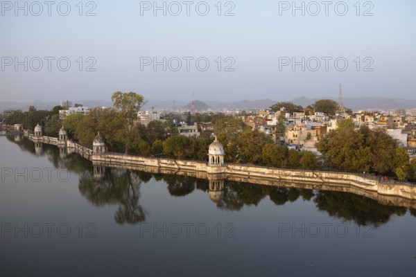 Pagodas in Swaroop Sagar Garden at Swaroop Sagar Lake in evening light, the city in the background,