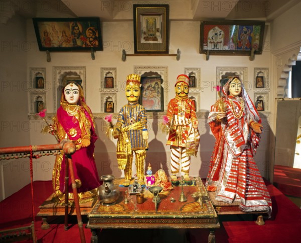 Indian traditional woman and men, dolls, worshipping Radha Krishna in the City Palace Museum, City
