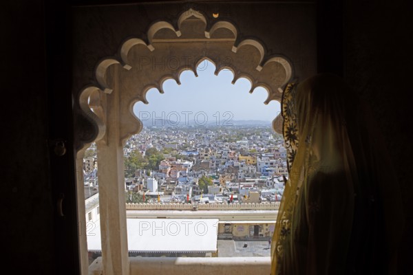 Indian woman with headscarf looking at the city, City Palace Museum, City Palace or City Palave,