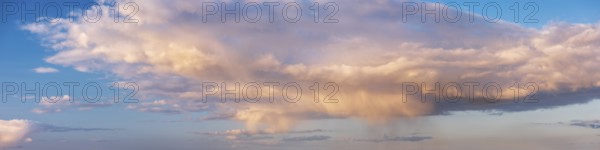 Wallpaper for sky replacement, evening sky with illuminated clouds, soft pastel colours and rain