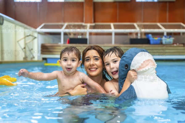 Happy family enjoying time together, playing with inflatable toy in swimming pool during summer