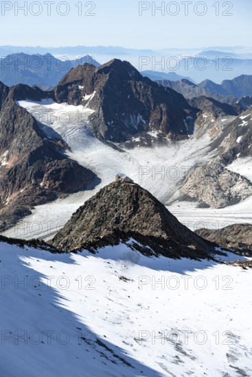 At the Wilder Freiger summit, picturesque high mountain landscape with snow, view of the