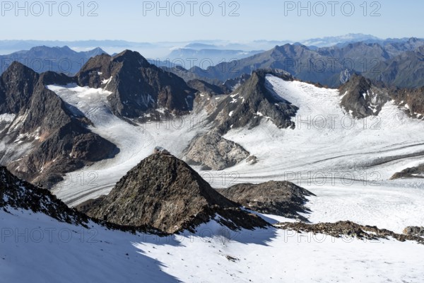 At the Wilder Freiger summit, picturesque high mountain landscape with snow, view of the