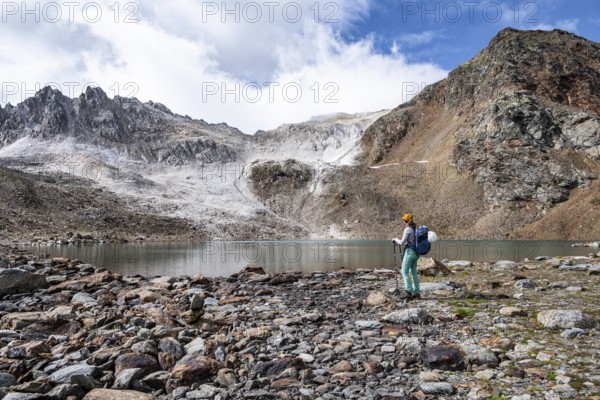 Mountaineer in front of mountain landscape with limestone rocks between granite mountains, mountain