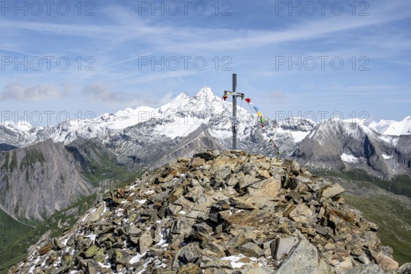Summit cross of the summit Böses Weibl, behind summit of the Großglockner with snow, Schober group,